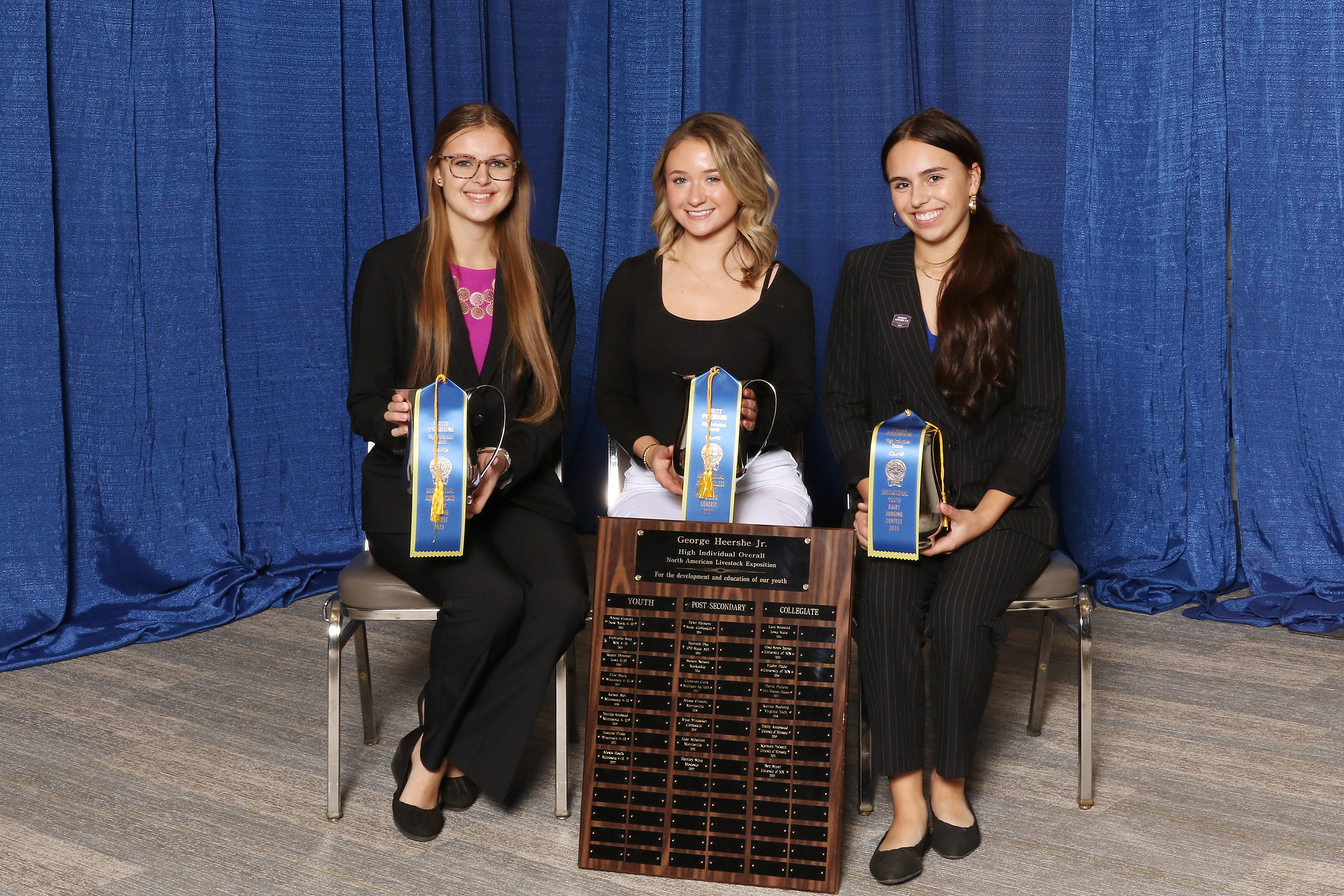 teenagers holding ribbons and trophy