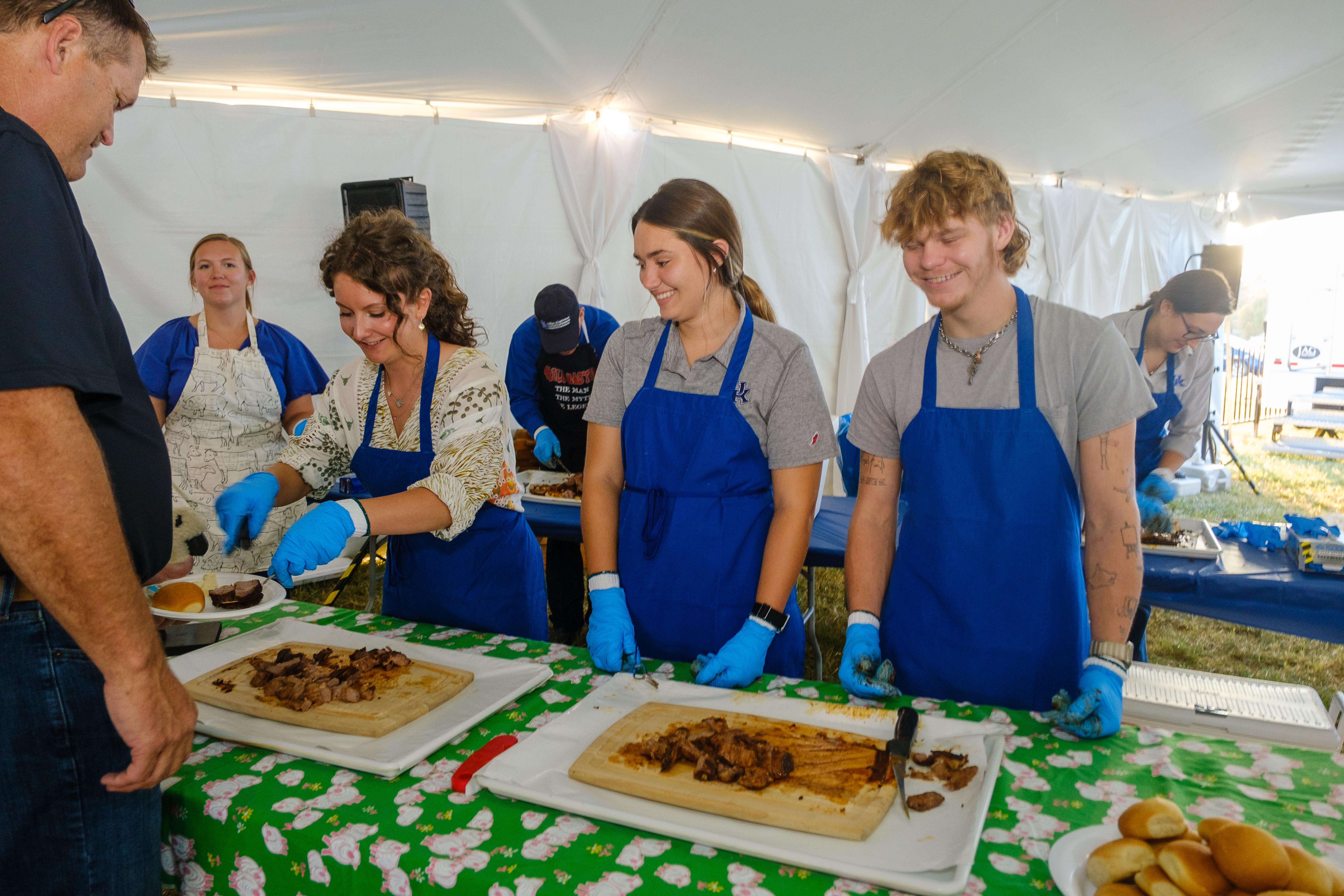 Several people serving food.