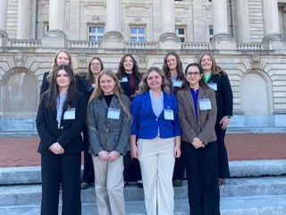 Students standing in front of the capitol 